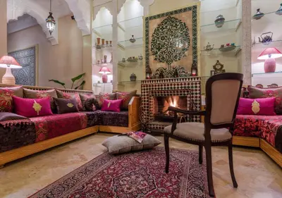 a living room with a couch and a chair at Riad Des Nations in Marrakech