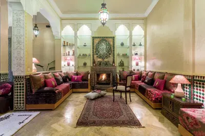 a living room with couches and a fireplace at Riad Des Nations in Marrakech