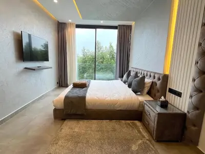 a bedroom with a large bed and a large window at Palais Thami in Marrakech