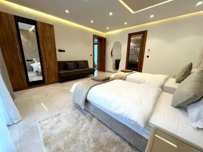 a large bedroom with two beds and a couch at Palais Thami in Marrakech