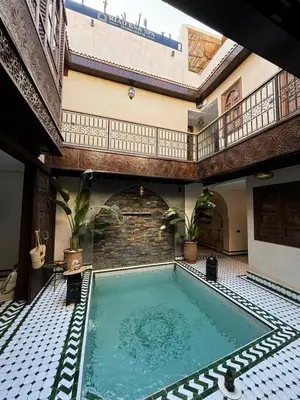 an indoor swimming pool in a building with a ceiling at RIAD KS & SPA in Marrakech