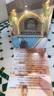 a menu for a restaurant with a pizza oven at RIAD KS & SPA in Marrakech