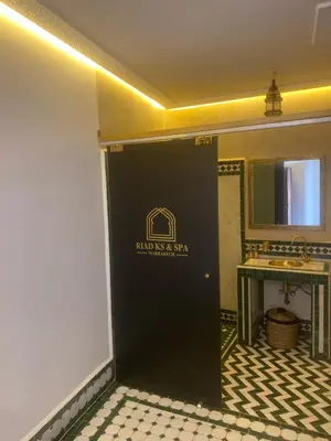 a black door in a bathroom with a sink at RIAD KS & SPA in Marrakech