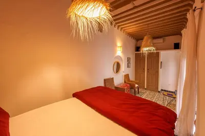a bedroom with a red bed in a room at Riad Kiwi - Private Historic Riad Jacuzzi & Hammam - Entire Home in Marrakech