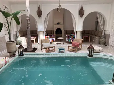 a swimming pool in a room with a living room at Riad Zayn & Spa in Marrakech