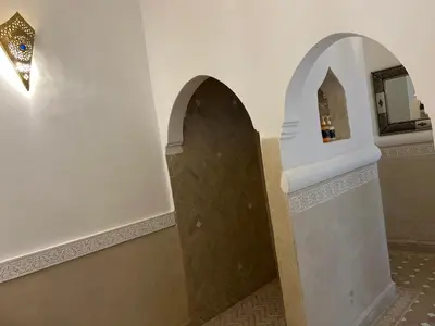a bathroom with a shower with a tile floor at Riad Zayn & Spa in Marrakech