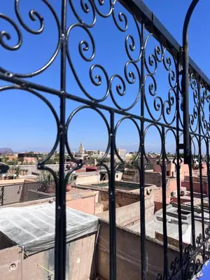 a view of a city through a wrought iron fence at Riad Dar Zarbia in Marrakech