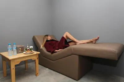 a woman laying on a couch with her feet on a table at THE FARM LODGES & Private pool in Marrakech