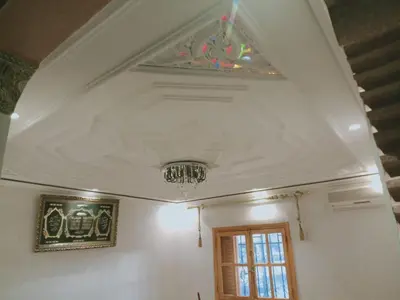 a room with a ceiling with a chandelier and a window at Airport Home in Marrakech