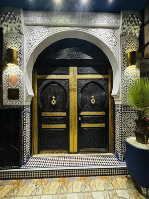 a pair of black doors in a building at Riad & Spa Stella Cadente Marrakech in Marrakech