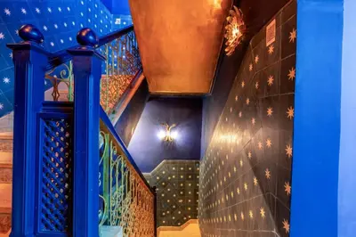 a staircase with a blue wall and a blue stair case at Riad & Spa Stella Cadente Marrakech in Marrakech