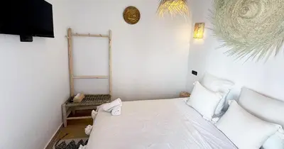 a bedroom with a white bed with white pillows at Couloirs de la Médina in Marrakech