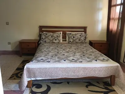 a bedroom with a bed with two nightstands and a bed sidx sidx sidx at Riad sofia in Marrakech