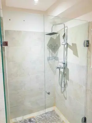 a shower with a glass door in a bathroom at New! Appartement en plein centre ville in Marrakech