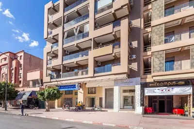 an apartment building on the corner of a street at New! Appartement en plein centre ville in Marrakech