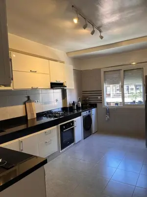 a kitchen with white cabinets and a stove top oven at Majorel Blue in Marrakech