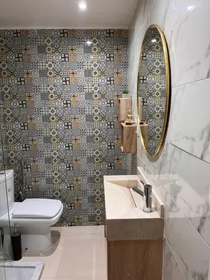 a bathroom with a toilet and a sink and a mirror at Majorel Blue in Marrakech