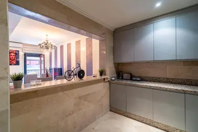 a kitchen with white cabinets and a bike on a counter at Appartement Haut standing Gueliz Plaza in Marrakech
