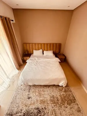 a bedroom with a bed with a rug on the floor at Séjour idéal a Marrakech - Villa spacieuse tout confort in Marrakech