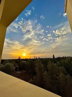 a view of a sunset from a balcony at Séjour idéal a Marrakech - Villa spacieuse tout confort in Marrakech