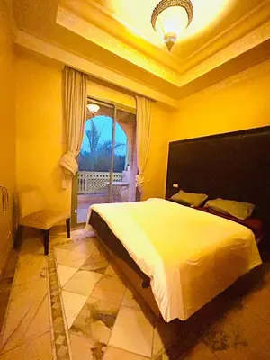 a bedroom with a large bed and a window at Appartement Spacieux avec Piscine à la Palmeraie in Marrakech