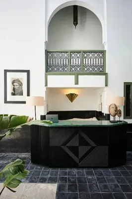 a lobby with a desk in a room at Riad Dar Nakous in Marrakech