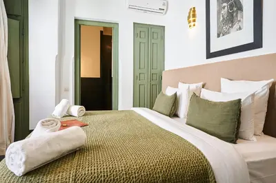 a bedroom with a large bed with towels on it at Riad Dar Nakous in Marrakech