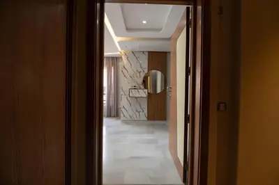 a hallway with a door leading into a room with a tile floor at Riad Gardens Two Bedroom Apartment in Marrakech
