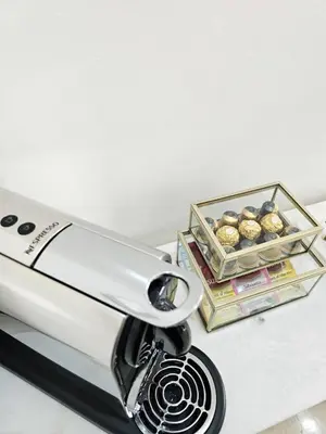 a toaster sitting on a counter next to a box of muffins at Coeur de Marrakech : Luxe, ciné & confort in Marrakech