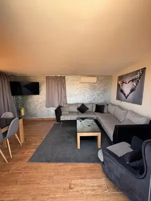 a living room with a couch and a table at Appartement Luxueux au Rooftop à Guéliz in Marrakech