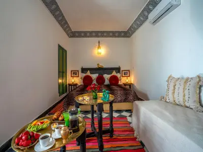 a living room with a couch and a table with food on it at Riad dada Messouda spa in Marrakech