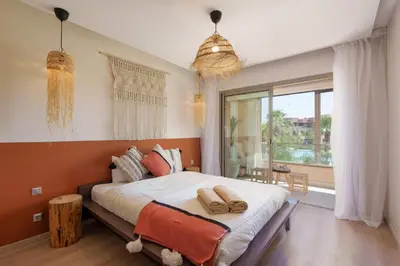 a bedroom with a large bed and a large window at Stylish Bliss - Dream Apartment in Marrakech