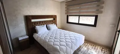 a bedroom with a large white bed with a window at Appartement spacieux & lumineux à Gueliz in Marrakech