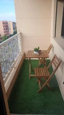 a patio with a table and chairs on a balcony at Appartement spacieux & lumineux à Gueliz in Marrakech