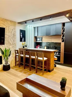 a kitchen with a bar and some chairs at Appartement Marrakech Hivernage N37 RESIDENCE CAPRICE PALACE in Marrakech