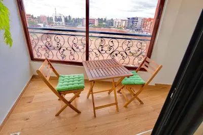 a balcony with a table and two chairs and a window at Appartement Marrakech Hivernage N37 RESIDENCE CAPRICE PALACE in Marrakech