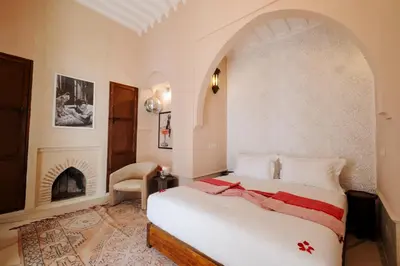 a bedroom with a bed and a fireplace at Riad Zi in Marrakech