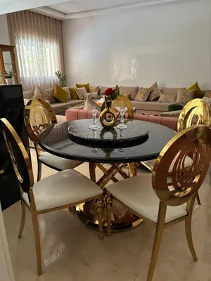 a living room with a table and chairs and a couch at Luxueux Duplex 3 Chambres piscine,terrasse Hivernage Centre Marrakech in Marrakech
