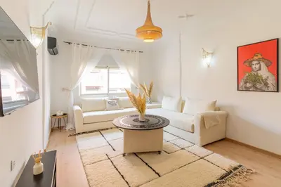 a living room with a couch and a table at Appartement centre Marrakech gueliz - Cool & Cozy Apartment for a Family Stay in the Heart of the City in Marrakech