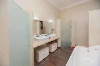 a bathroom with two sinks and a large mirror at Domaine Marradise in Marrakech