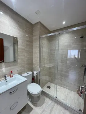 a bathroom with a shower and a toilet and a sink at Marrakech Prestigia 3 chambres in Marrakech