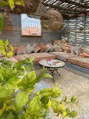 a living room with a couch and a table at Riad Kismet Marrakech in Marrakech