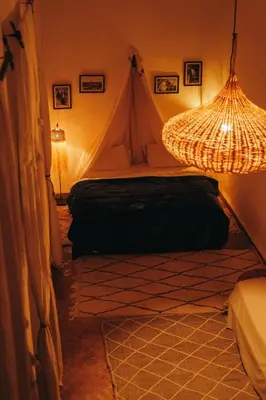 a bedroom with a tent and a chandelier at NOSADE Venue in Marrakech
