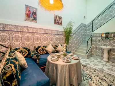 a living room with a blue couch and a table at Pretty Apartment in the Medina 2 in Marrakech