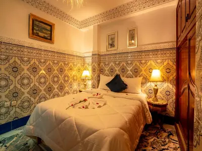a bedroom with a bed with flowers on it at Pretty Apartment in the Medina 2 in Marrakech