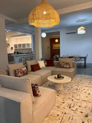 a living room with couches and a table at Loft Marrakech 5 min du centre super emplacement in Marrakech