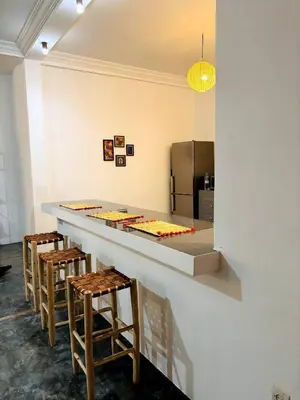 a kitchen with a long counter with stools at Loft Marrakech 5 min du centre super emplacement in Marrakech