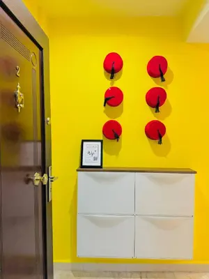 a yellow room with red umbrellas on a wall at Le Gueliz Centeral cosy Suite in Marrakech