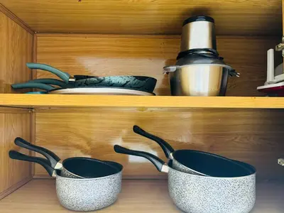 two pots and pans on shelves in a kitchen at Le Gueliz Centeral cosy Suite in Marrakech