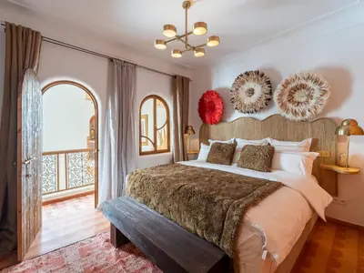a bedroom with a large bed and a large window at Riad Nesayam - Riad Privatisé - 3 Suites - Piscine Chauffée in Marrakech